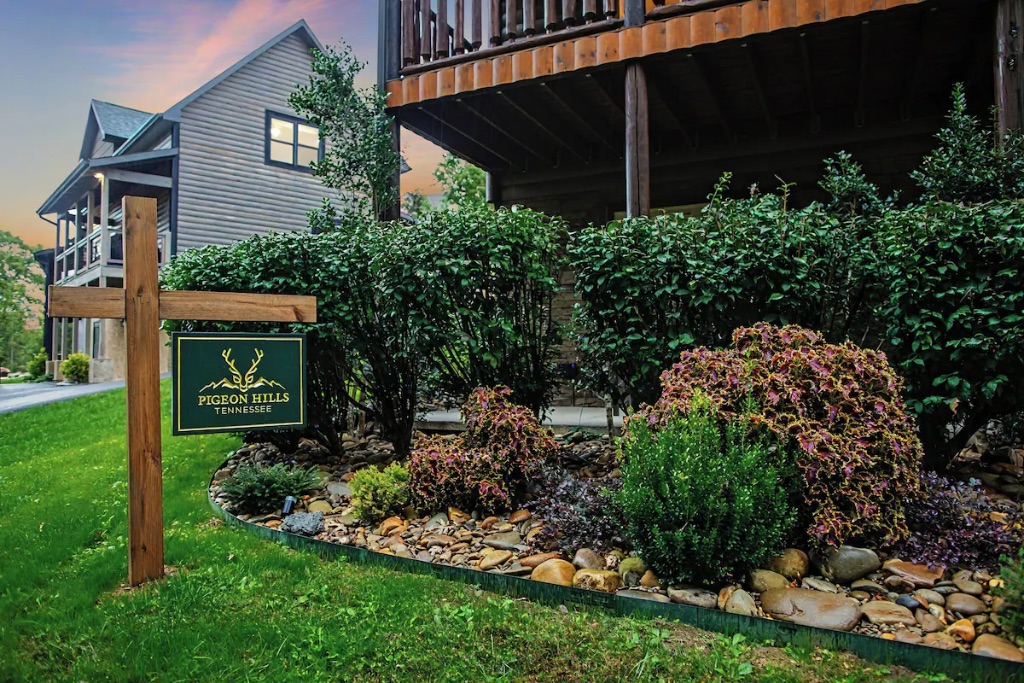 Pigeon Hills cabin exterior with Pigeon Hills Tennessee sign landscaping and autumn sunset